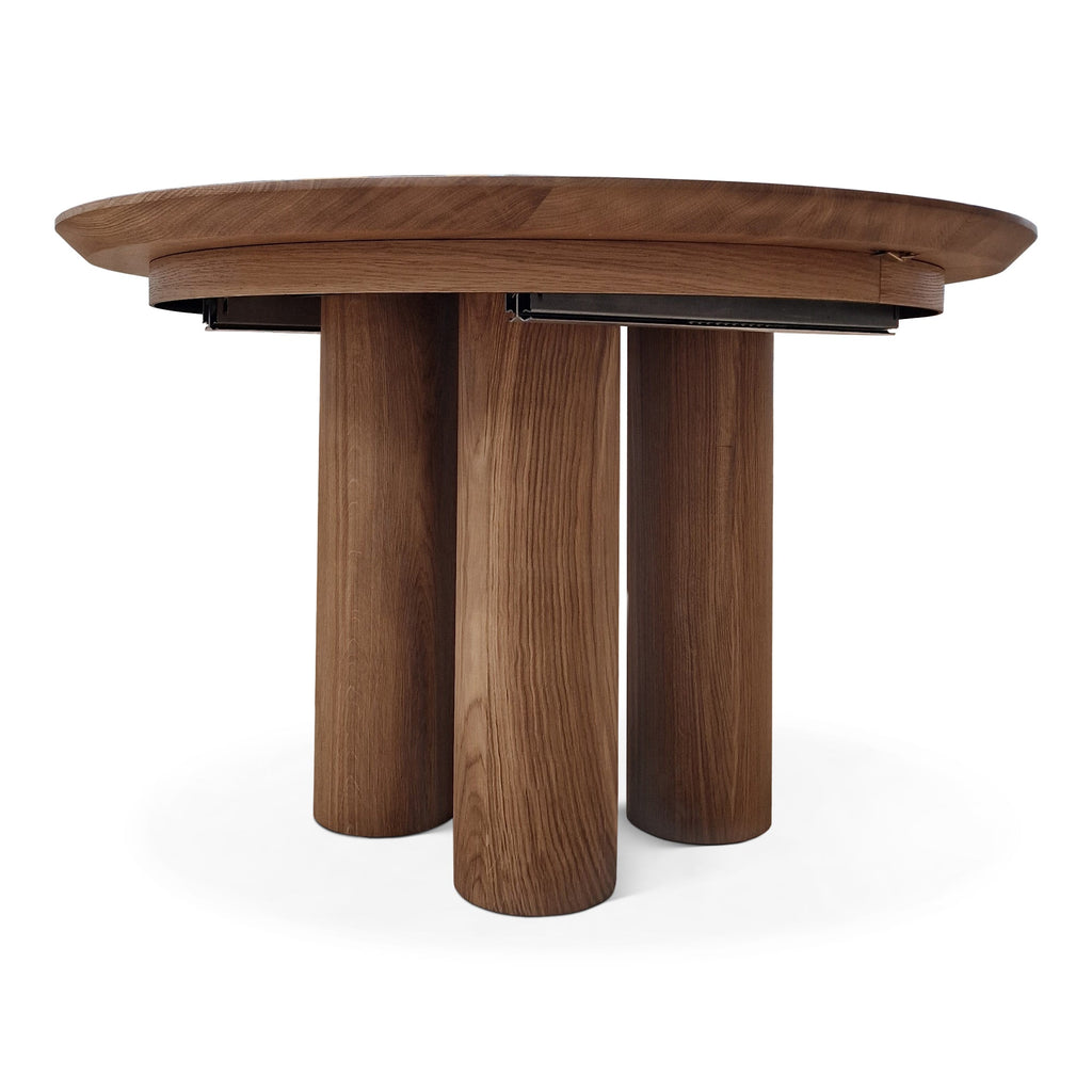 Table de salle à manger ronde extensible en noyer – Cette luxueuse table de salle à manger ronde – fabriquée à la main par des experts à partir de noyer européen massif de première qualité (teinte plus foncée de